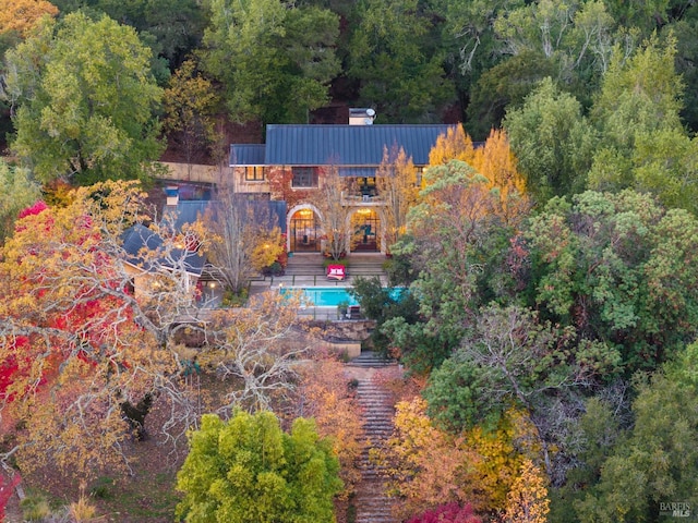 drone / aerial view with a wooded view