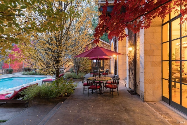 view of patio / terrace featuring an outdoor pool and outdoor dining space