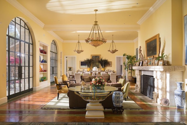 dining room featuring wood-type flooring, a fireplace, built in features, and crown molding