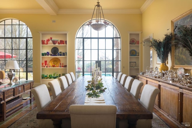 dining room with built in features, crown molding, and beamed ceiling