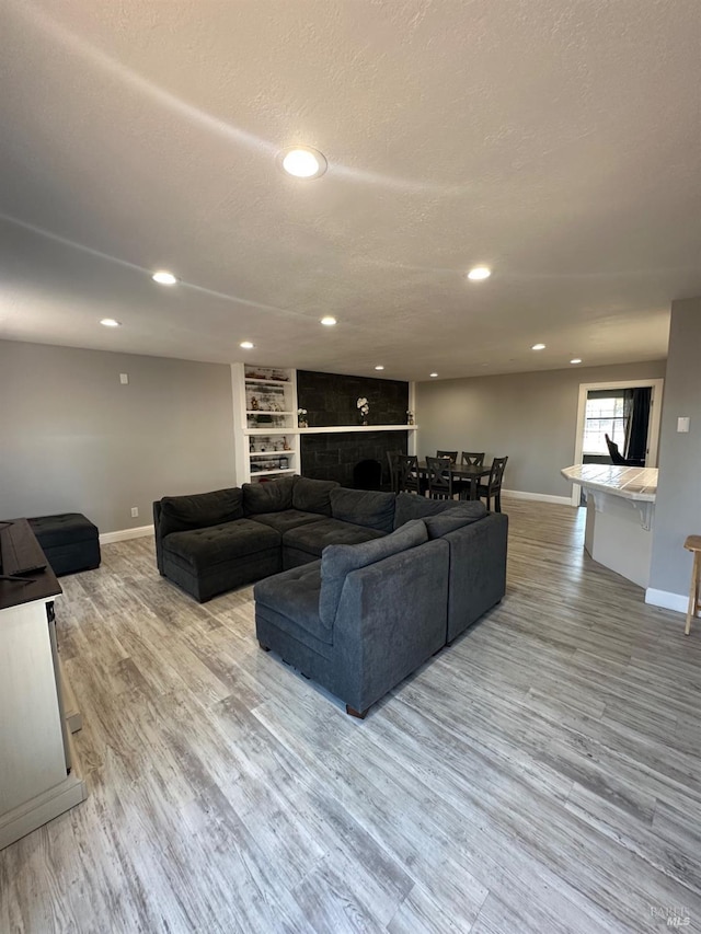 living room with light hardwood / wood-style flooring and a textured ceiling