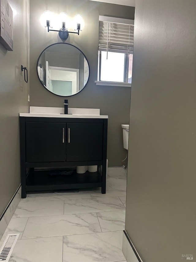 bathroom with vanity and toilet