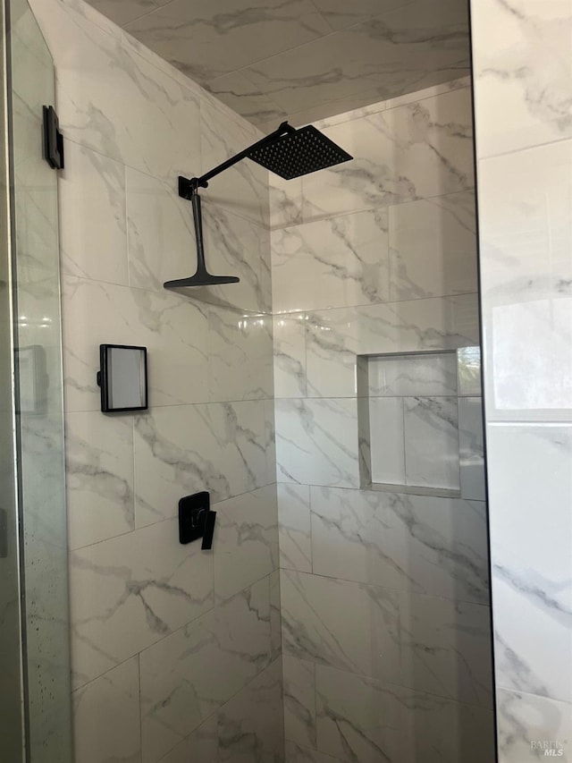 bathroom with a tile shower