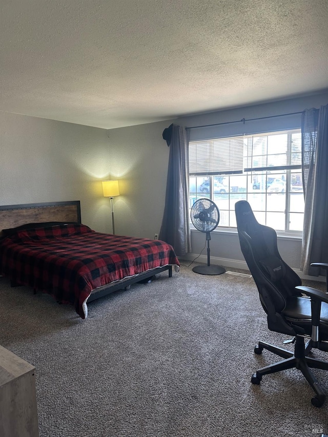 carpeted bedroom with a textured ceiling