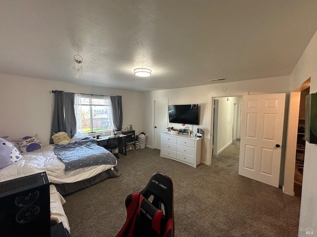 bedroom with carpet and a textured ceiling