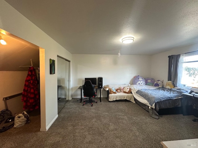 carpeted bedroom featuring a textured ceiling