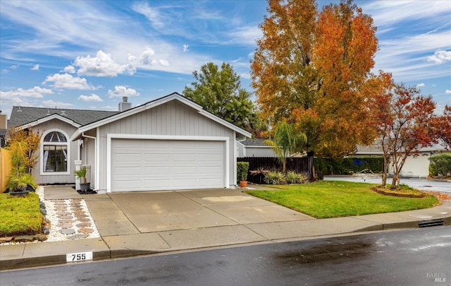 ranch-style house with a garage and a front lawn