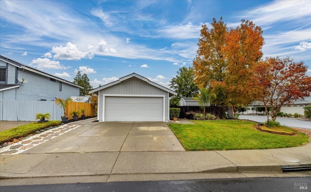 view of front of property featuring a garage and a front lawn