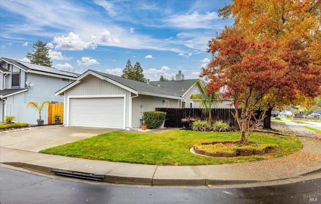 view of front of property featuring a garage and a front lawn