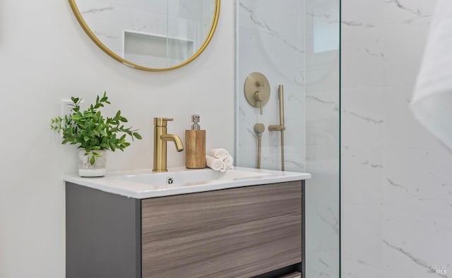 bathroom with vanity and a tile shower