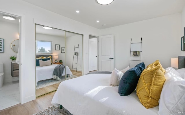 bedroom featuring light hardwood / wood-style floors and a closet