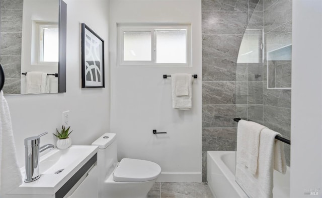 bathroom featuring vanity, toilet, and baseboards