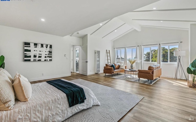 bedroom featuring beamed ceiling, high vaulted ceiling, and light wood-type flooring