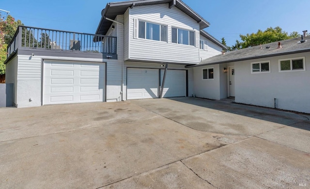 view of front facade with a garage and a balcony