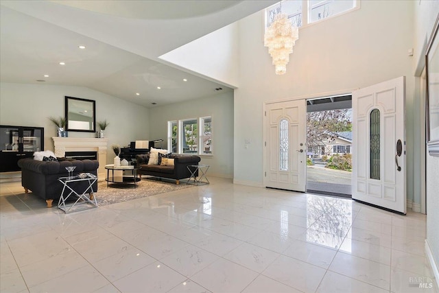 foyer entrance featuring a notable chandelier and high vaulted ceiling