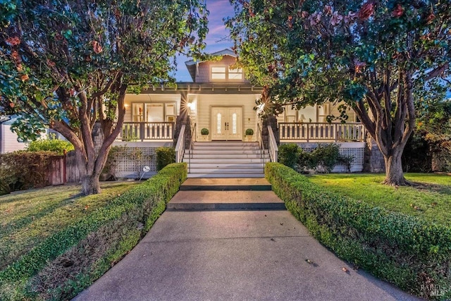 view of front of property with a lawn and covered porch