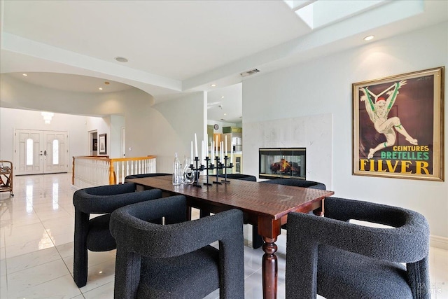 dining space with a fireplace and french doors