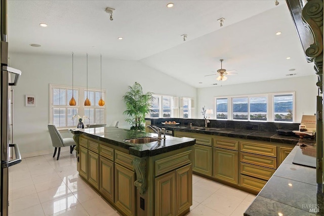 kitchen featuring vaulted ceiling, sink, a kitchen island with sink, and ceiling fan