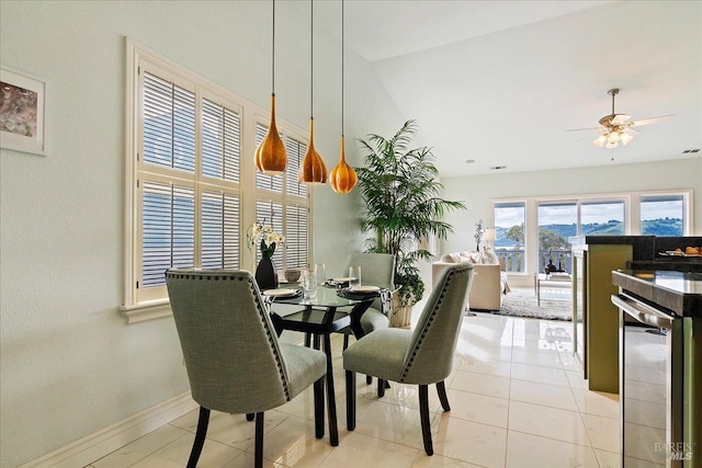 tiled dining room featuring wine cooler and ceiling fan