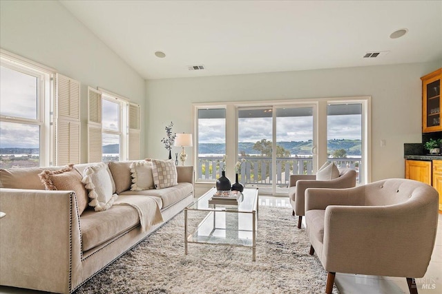 living room featuring a mountain view and vaulted ceiling