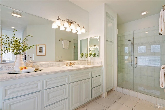 bathroom with tile patterned flooring, vanity, and an enclosed shower