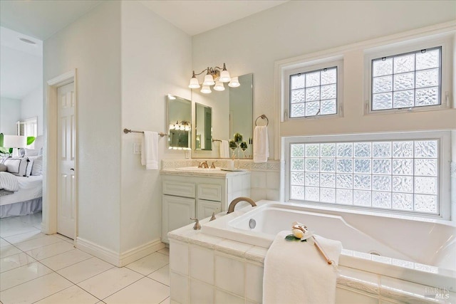 bathroom with vanity, tiled bath, and tile patterned floors