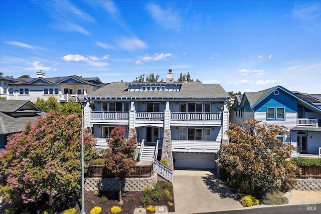 view of front of property featuring a garage and a balcony