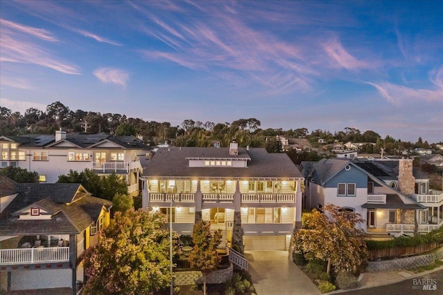 view of front of property featuring a garage and a balcony