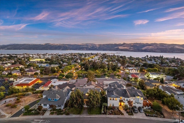 aerial view at dusk with a water and mountain view