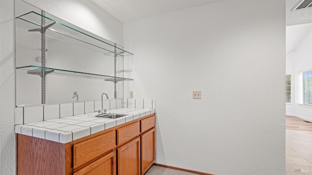 interior space featuring tile counters and sink