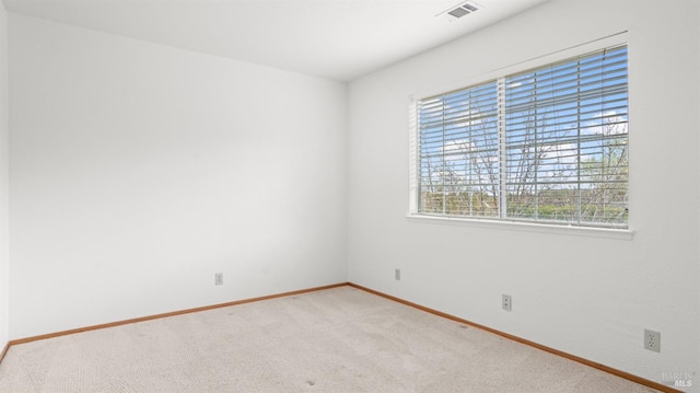 empty room featuring light carpet