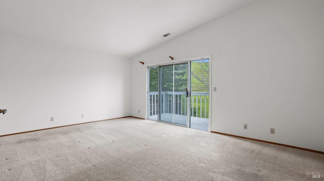 spare room with lofted ceiling and carpet flooring