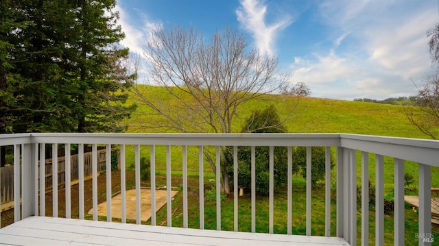 wooden terrace featuring a yard