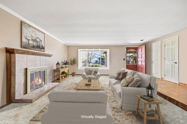 living room featuring ornamental molding, a tile fireplace, and light parquet floors