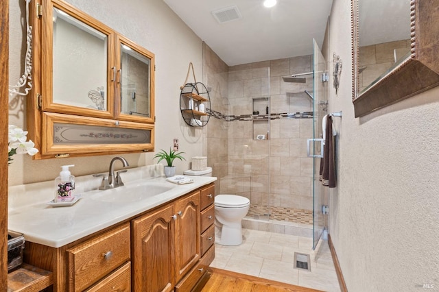 bathroom with vanity, toilet, and walk in shower