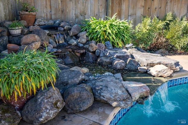 view of yard featuring a garden pond