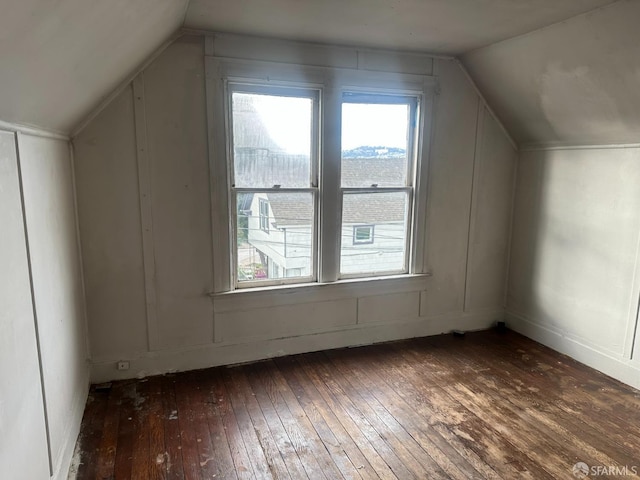 bonus room featuring dark hardwood / wood-style flooring and lofted ceiling