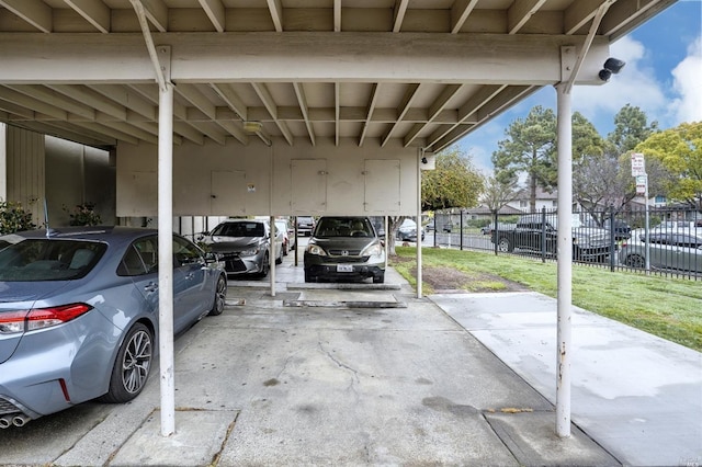 view of car parking featuring a carport and a yard