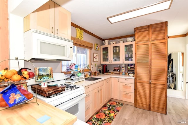 kitchen with sink, crown molding, white appliances, light hardwood / wood-style flooring, and light brown cabinets