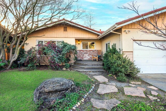 view of front of property with a garage and a front lawn