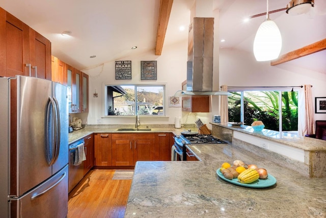 kitchen with pendant lighting, sink, appliances with stainless steel finishes, island exhaust hood, and kitchen peninsula