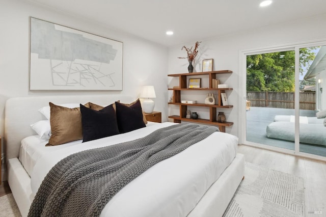 bedroom featuring access to outside and light hardwood / wood-style floors