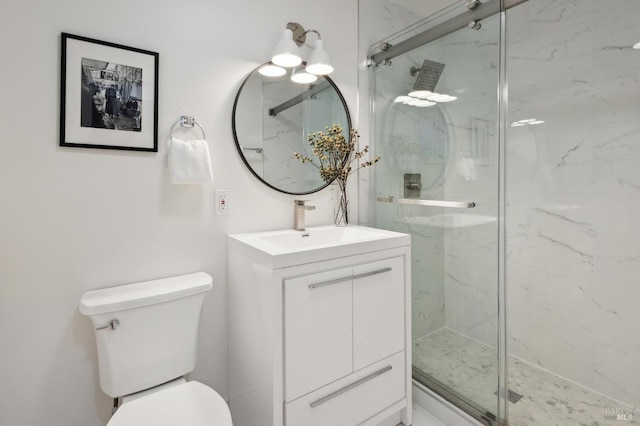 bathroom featuring walk in shower, vanity, and toilet