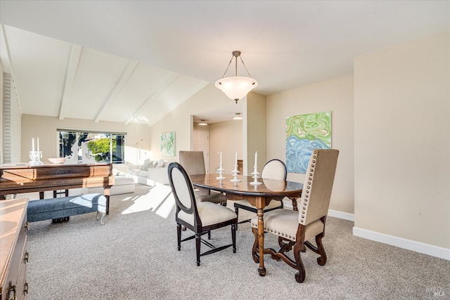 carpeted dining area featuring lofted ceiling with beams