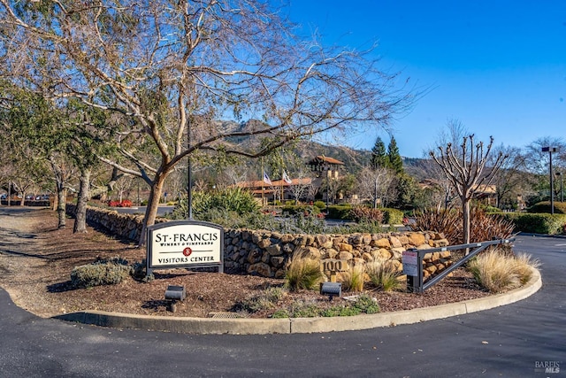 community / neighborhood sign with a mountain view