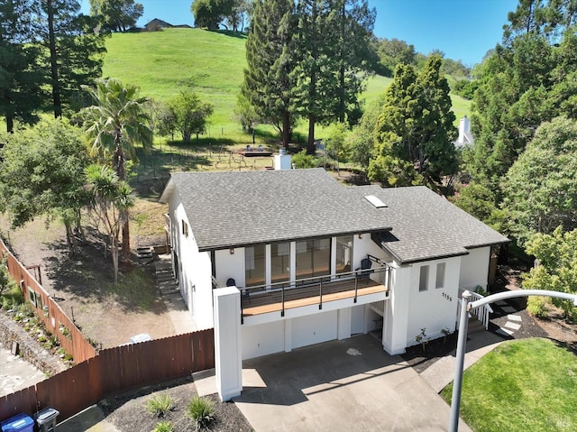 view of front of house featuring a garage and a balcony