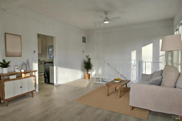 living room featuring ceiling fan and light wood-type flooring