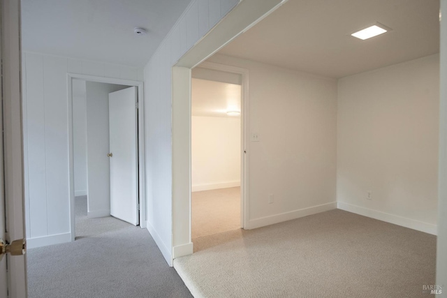 unfurnished room with light colored carpet