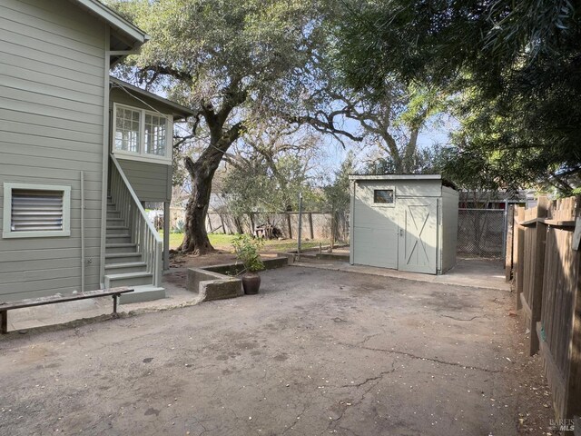 view of patio featuring a storage unit