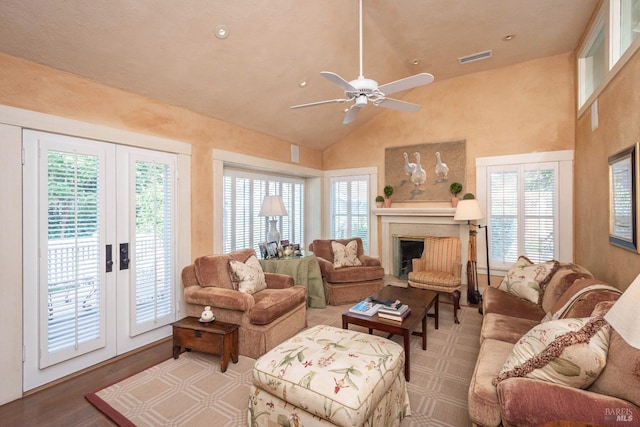 living room with wood-type flooring, ceiling fan, high vaulted ceiling, and french doors